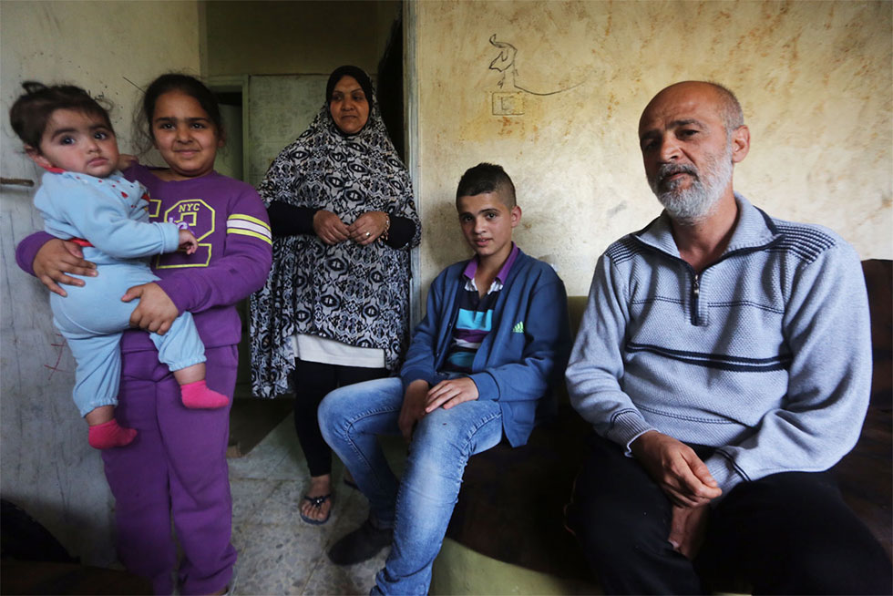 Aref Tutunji and several of his family members. "I just want my home." (Photo: Gil Yohanan)