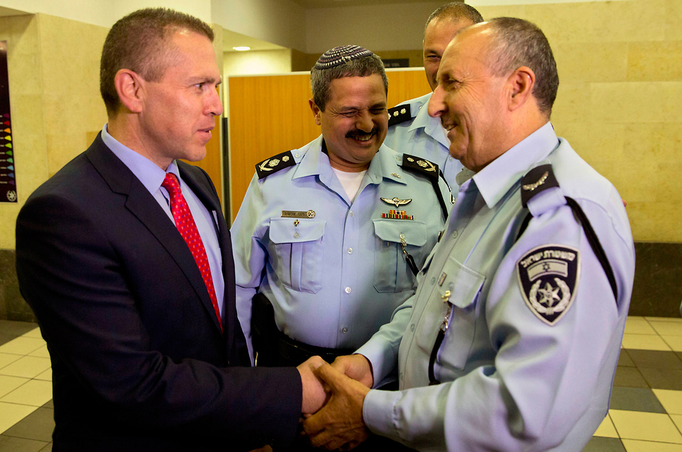 Gilad Erdan shakes hands with Gamal Hakroosh as he is appointed Northern Police Commissioner (Photo: AP)