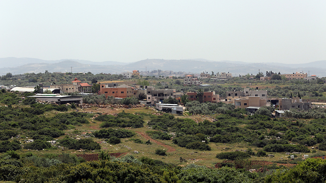 Many buildings in the West Bank are illegally built, thus aren't connected to the water grid (Photo: Gil Yohanan)