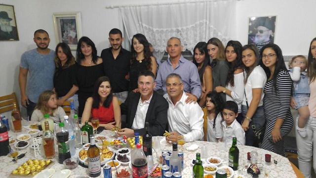Former Likud minister Gideon Sa'ar celebrates with the Buskila family in Ashkelon