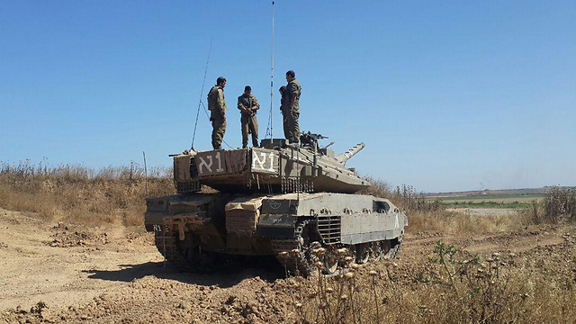 Soldiers on the Gaza border stand on their tanks during the 2-minute siren (Photo: Roee Idan)