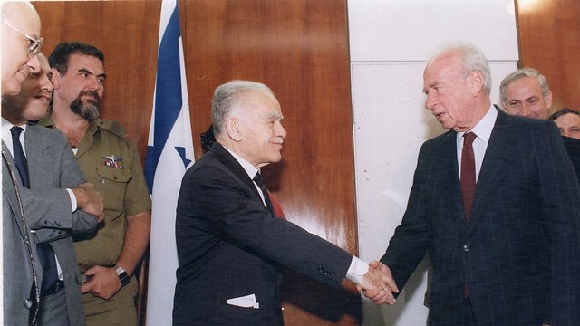 Nevo, to the left in uniform, looks on as Rabin enters office as Shamir leaves (Photo: Zoom 77)