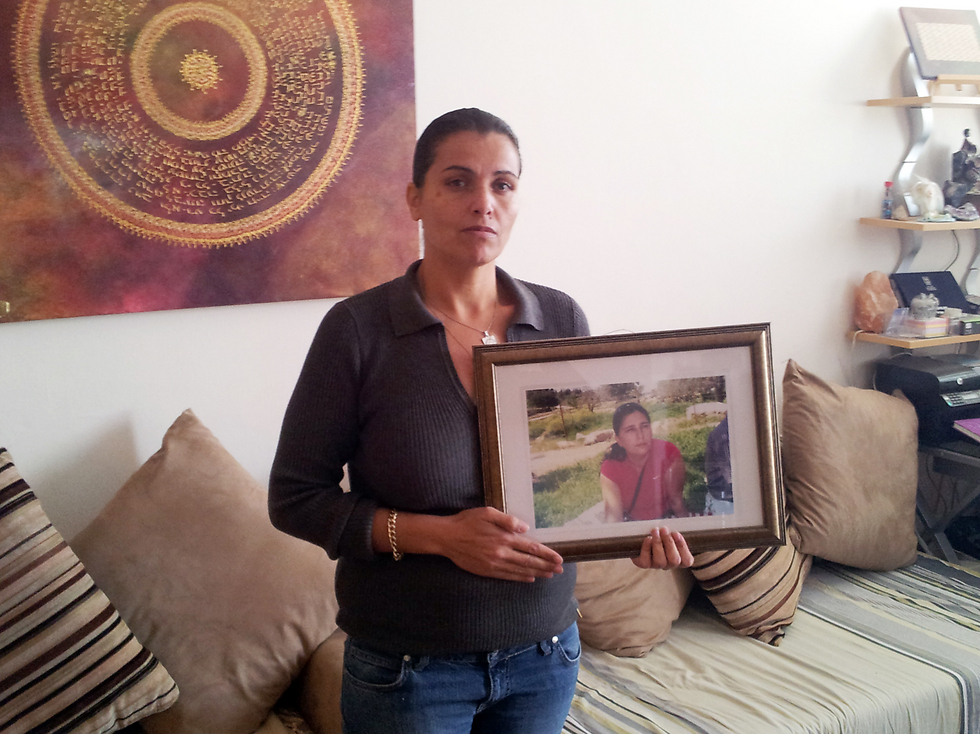Rachel Elgabsi holding a photograph of her late wife, Police Lt. Fabiola Bohadana
