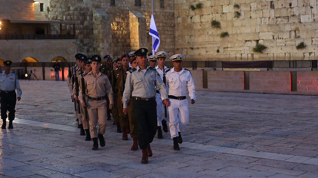Lowering the flag to half staff (Photo: Gil Yohanan)