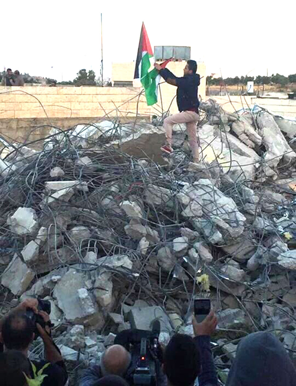 The Palestinian flag on the demolished home.