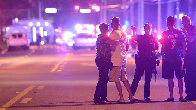 Police and civilians outside the club (Photo: AP)