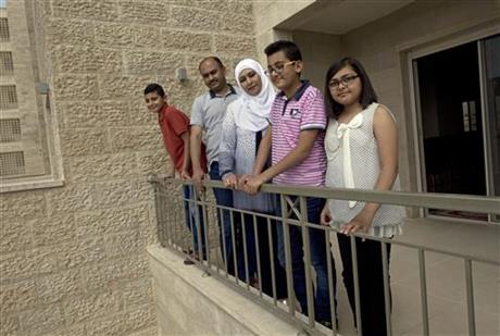 The al Khateeb family gather for a photo on the terrace of their newly delivered apartment.