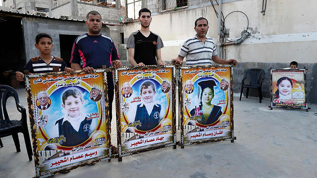 Members of the Shuheibar family with photos of the children killed (Photo: AFP