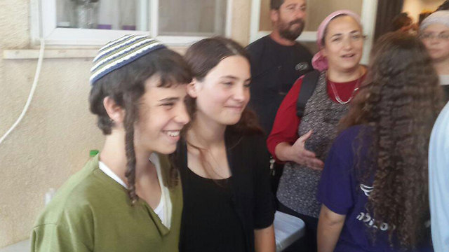 Tehila Mark with her brother Pedayah upon her release from the hospital (Photo: Mount Hebron Spokesman)