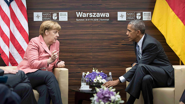 US President Barack Obama speaking to German Chancellor Angela Merkel at the NATO summit in Warsaw (Photo: Reuters)