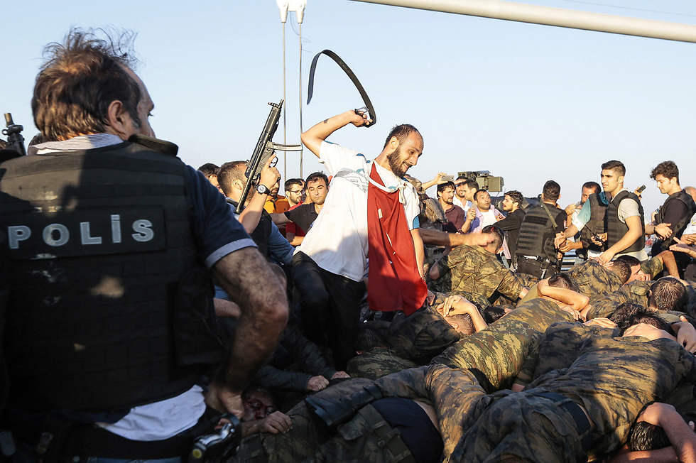 A man whips soldiers who participated in the attmpted coup with his belt (Photo: Gettyimages) (Photo: gettyimages)