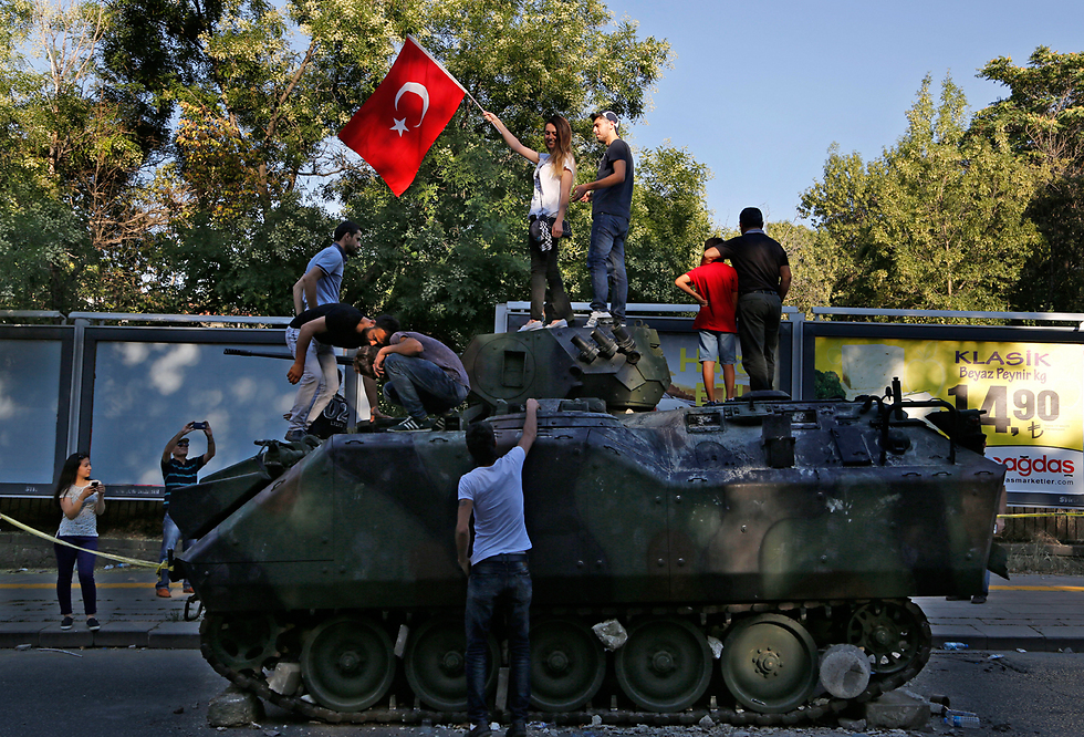 Turkish civilians on a tank (Photo: AP)