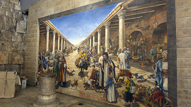 The mural depicts a representation of the commercial and cultural life along the Cardo in Roman period Jerusalem. Next to it is a pillar base, left from the ancient Roman colonnade. (Photo: Andrew McIntire/TPS)