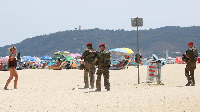 French soldiers patrolling the beach in France (Photo: MCT)