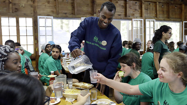 Salat Ali pours water for his group of campers. (Photo: AP)