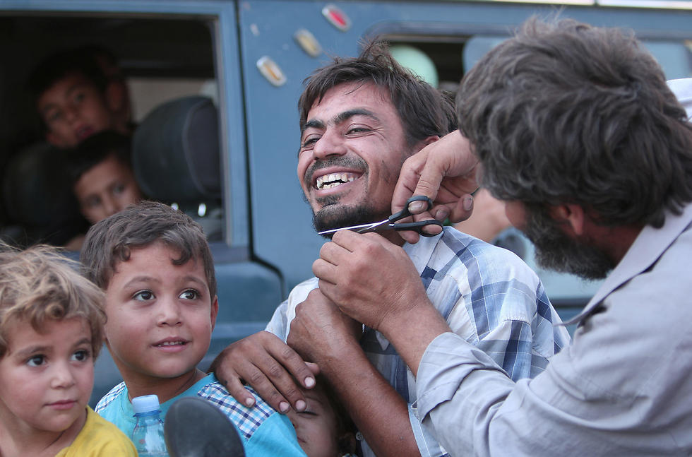 Men cut their beards in Manbij after the city's liberation by SDF forces. ISIS imposes a strict Islamic dress code on the population under its control