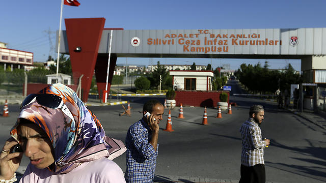 Relatives and friends of prisoners wait outside a high security prison complex in Silivri (Photo: AP)