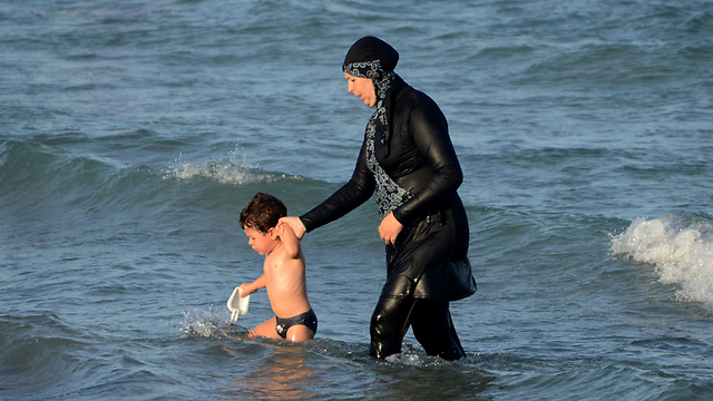 "בגד שאף אישה משוחררת לא יכולה לקבל". מוסלמית בבורקיני בחוף הים במרוקו (צילום: AFP) (צילום: AFP)