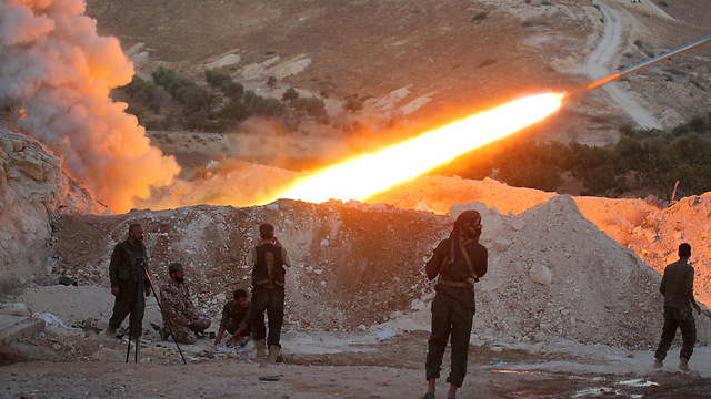 Regime soldiers fire a grad rocket in the Hama region (Photo: Reuters)
