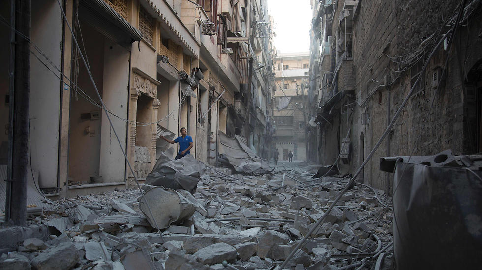 Standing in a street in Aleppo, examining the aftermath of the attack (Photo: EPA)