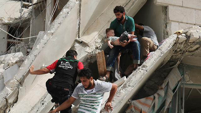 Evacuating the wounded from the wreckage in Aleppo following the recent onslaugh (Photo: AFP)