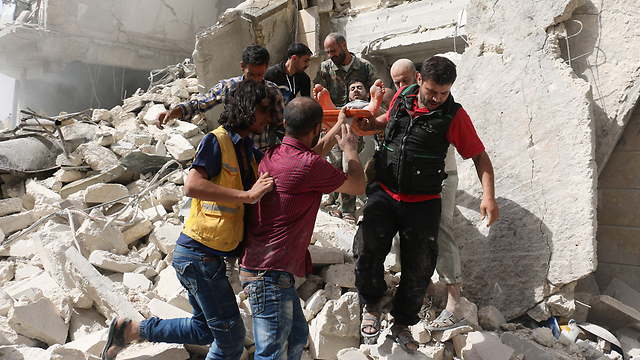 Evacuating the wounded from the wreckage in Aleppo following the recent onslaugh (Photo: AFP)