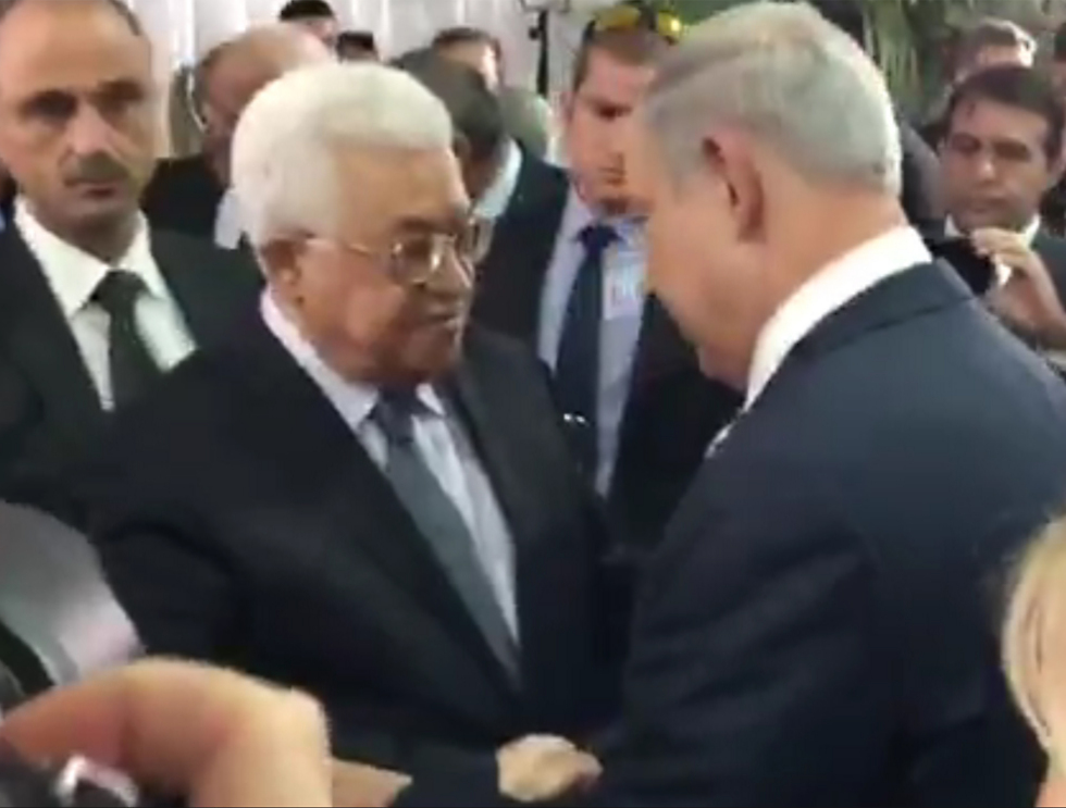 Palestinian President Abbas shakes PM Netanyahu's hand
