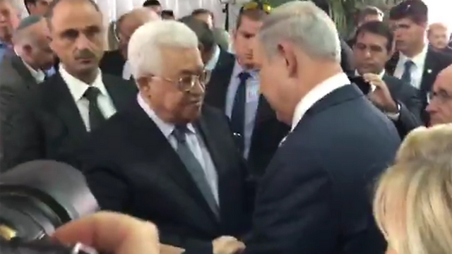 Prime Minister Netanyahu, right, shaking Palestinian President Abbas's hand at Peres's funeral.