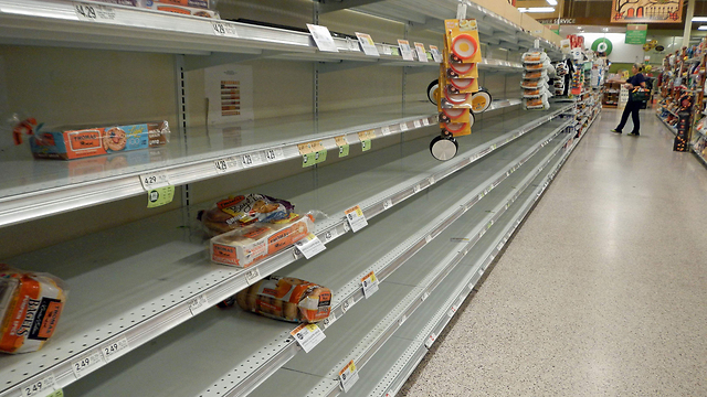 A supermarket emptied-out before the storm (Photo: AFP)