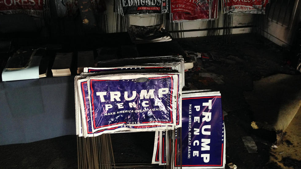 Melted Trump-Pence signs in the burned office. (Photo: AP)