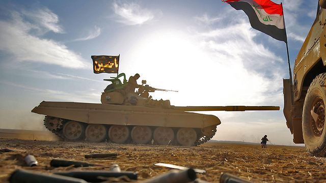 A Shia flag reads 'Ya Hussein' on an Iraqi tank (Photo: AFP)