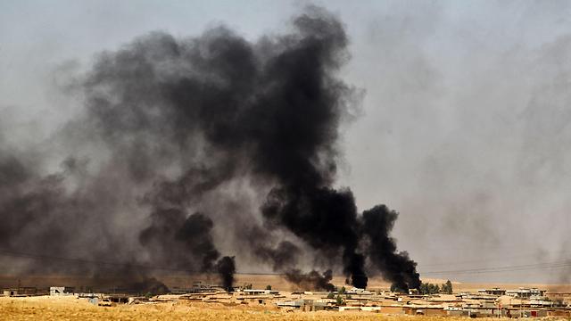 A village burns as Iraqi and Peshmerga forces approach Mosul (Photo: AFP)