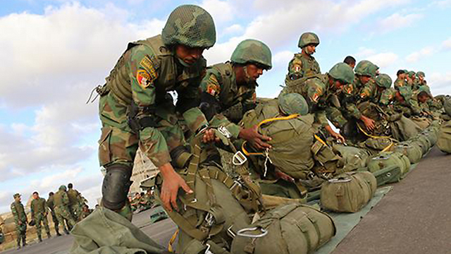 Egyptian paratroopers prepare their parachutes