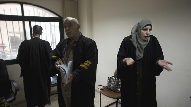 Reema Shamashneh (R) speaks with her colleagues during a break at the Islamic family court in Ramallah (Photo: AP)