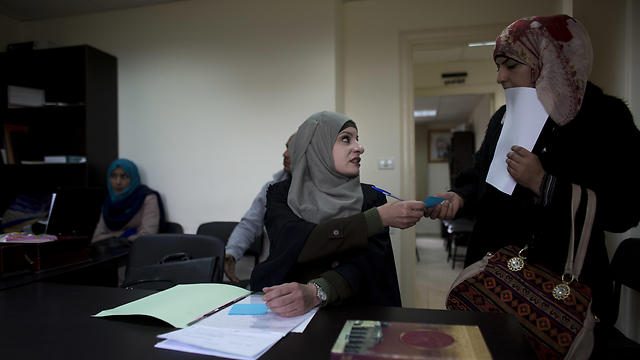 Reema Shamashneh talks to her client in the Islamic family court in Ramallah (Photo: AP)