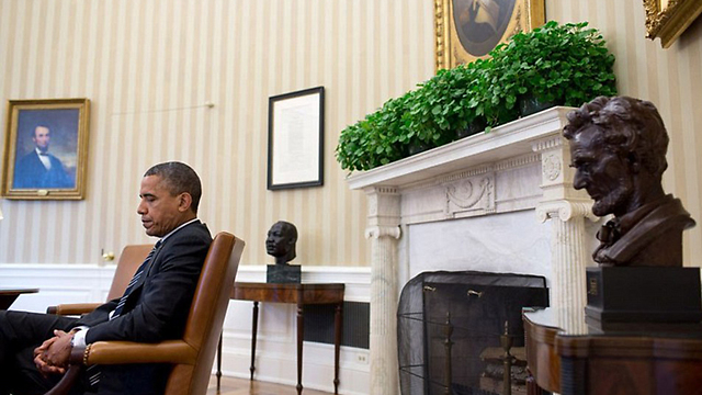 בין נשיאים: אובמה נתפס ברגע של מחשבה בין פסל ותמונה של לינקולן (צילום: Offical White House Photo) (צילום: Offical White House Photo)