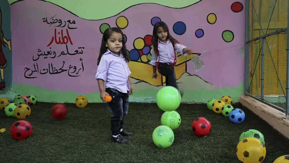 Abdel Ghani al-Attar, right, and his brother Esam, play at a kindergarten not far from their family house in Rafah (Photo: AP)