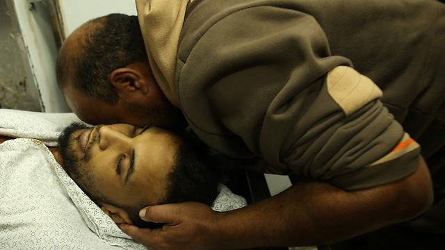  A relative mourns over the body of Mohammed Abu Saada (Photo: AFP)