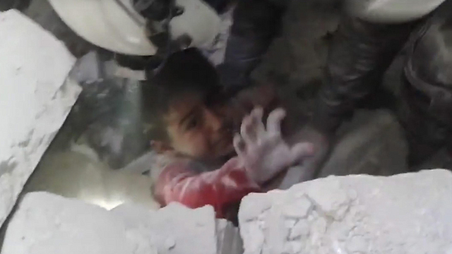 A child being pulled out of the rubble in Aleppo (Photo: EPA)