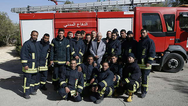 Palestinian firefighters after helping to extinguish Nahf fire (Photo: AFP) (Photo: AFP)