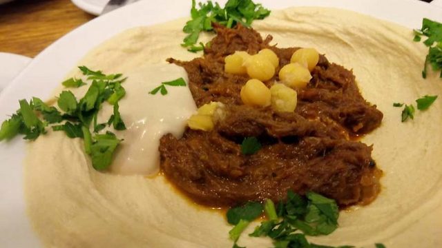Hummus with pulled barbeque beef (Photo: Linda Gradstein/ The Media Line)