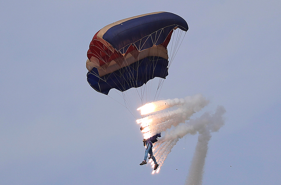 A man parachutes with pyrotechnics in North Korea (Photo: AP)