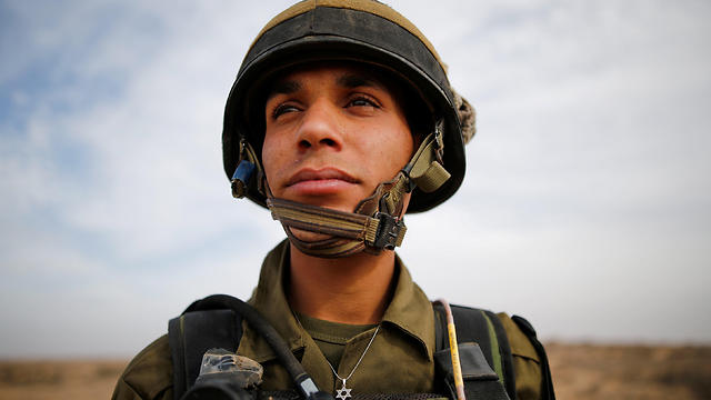 Sgt. Yusef Salutta stands in an IDF uniform wearing a Star of David (Photo: Reuters)