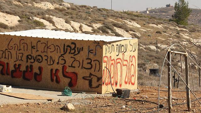 A building in the settlement of Amona, grafittied with signs of resistence to the evacuation (Photo: Motti Kimchi)