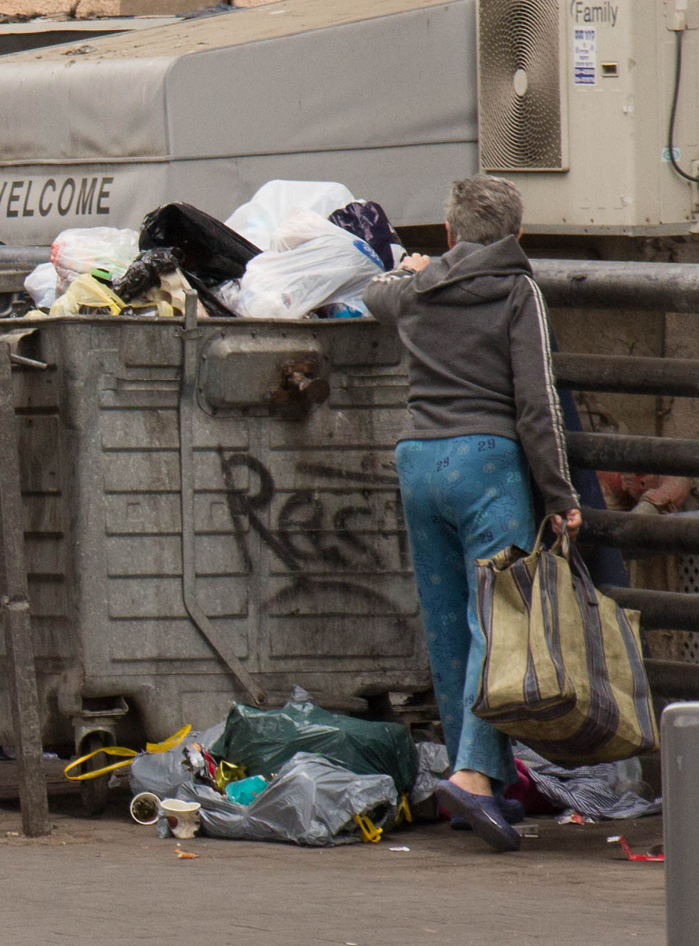 Homeless people go through garbage in search of food recyclable waste (Photo: Eran Granot)