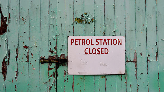 שלט ללקוחות בתחנת דלק שנסגרה לפני יותר מעשור בליברטון שבדבון, בריטניה (צילום: רויטרס) (צילום: רויטרס)