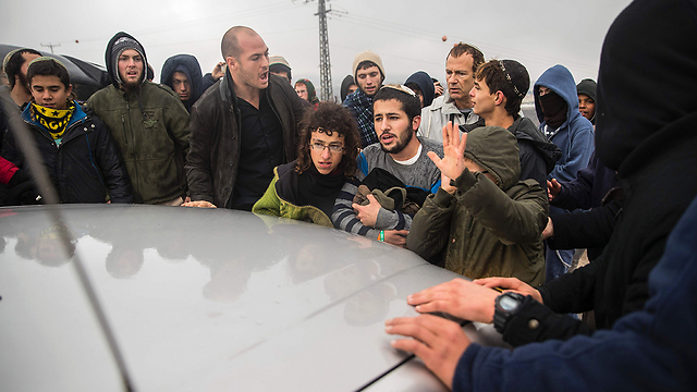 Activists surround Galant's car, refusing to let it through (Photo: AFP)