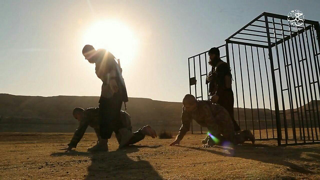 ISIS fighters leading Turkish soldiers out of their cage to their execution spot