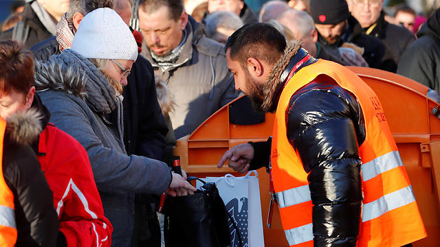 Visitors pass security check to enter the venue at the Brandenburg Gate on Friday (Photo: Reuters)