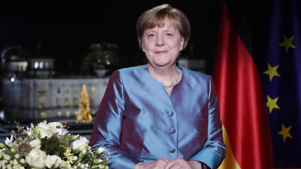 German Chancellor Angela Merkel poses for photographs after the television recording of her annual New Year's speech at the chancellery in Berlin (Photo: EPA)